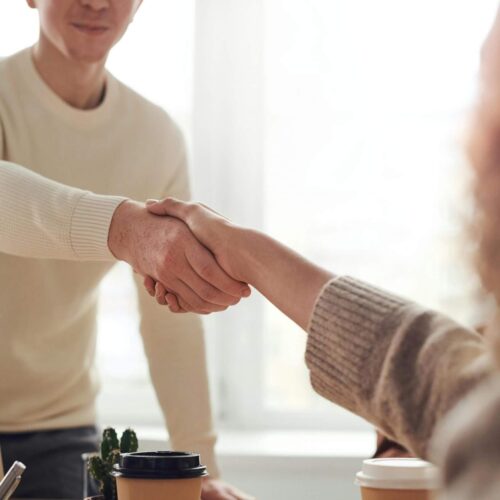 Student shaking hands with professor