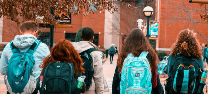 Students walking with backpacks on