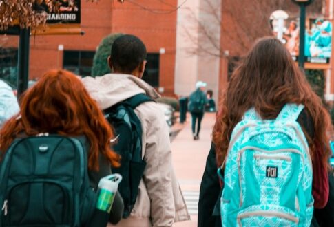Students walking with backpacks on