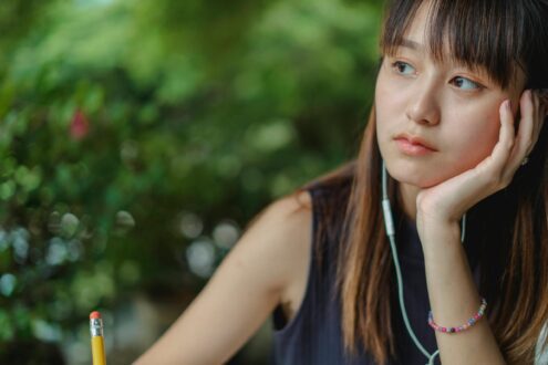 Girl thinking with air pods in